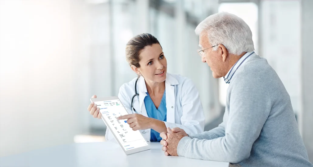 doctor displays Clarity report on a tablet to an elderly man